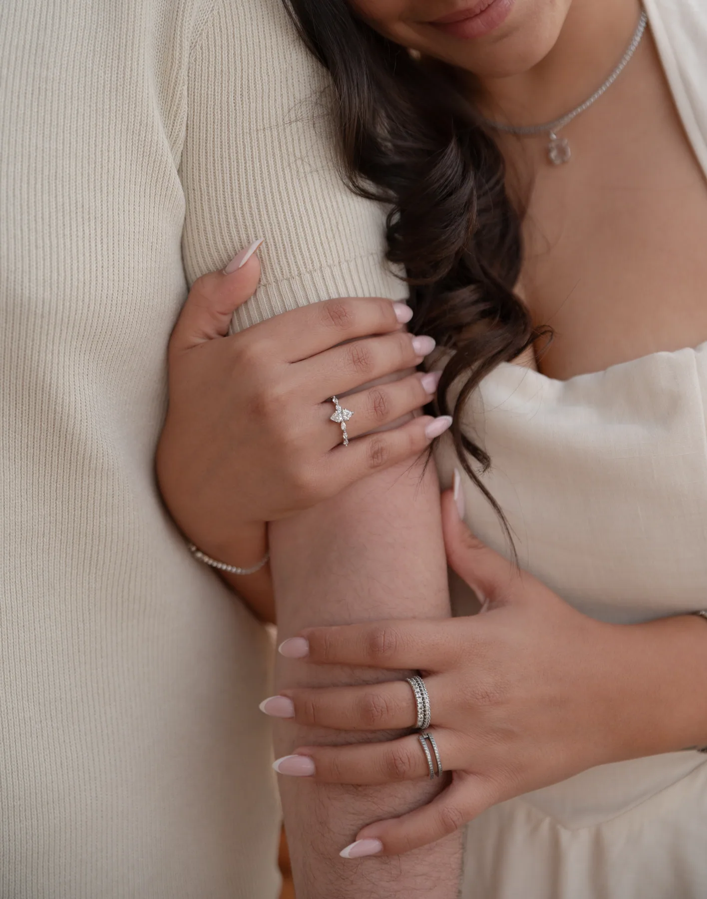 Her hand with the ring, held close